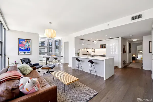 a living room with furniture and kitchen view