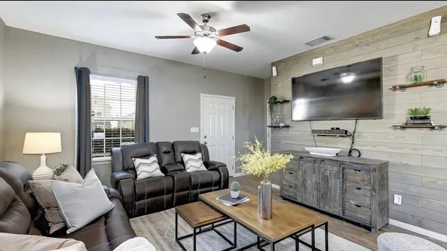a living room with furniture and a flat screen tv