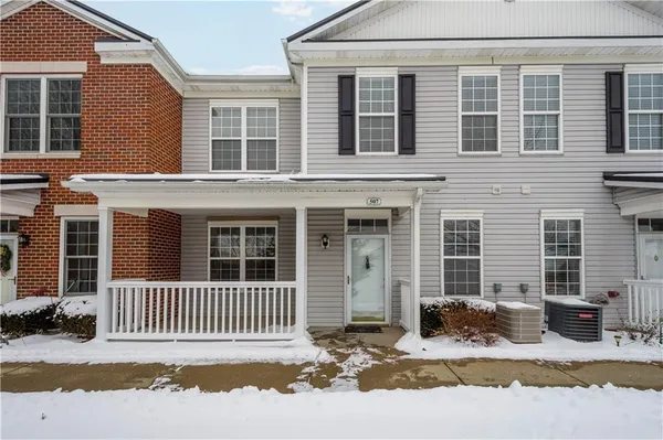 a front view of a house with a fence