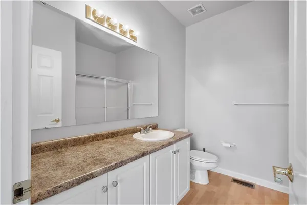 a bathroom with a glass shower door