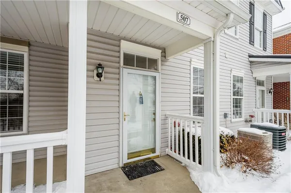 a view of a house with a door and wooden fence