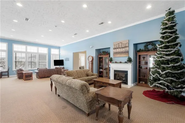a room with stainless steel appliances kitchen island granite countertop a sink and cabinets