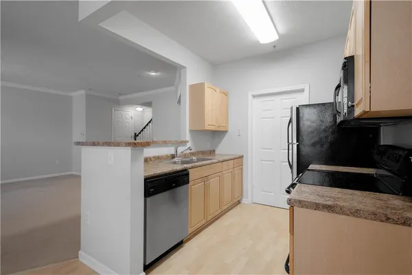 a kitchen with a sink and a stove top oven