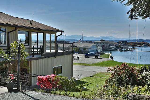 a front view of a house with a garden and sitting area