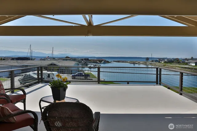 a terrace with a table and chairs under an umbrella