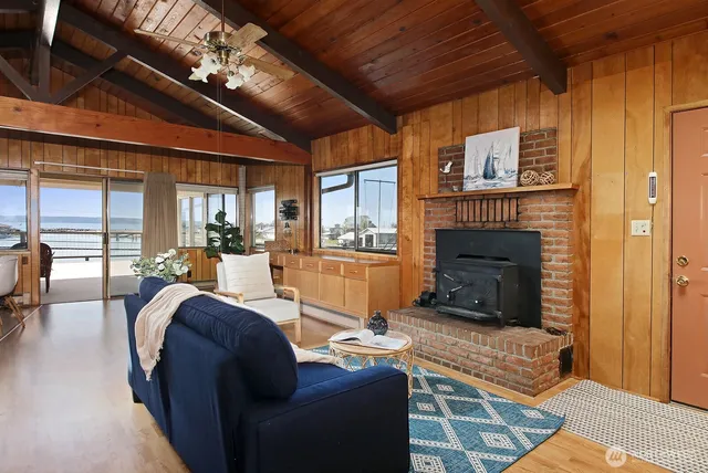a living room with furniture a fireplace and a table