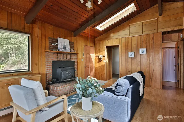 a living room with furniture a fireplace and a large window