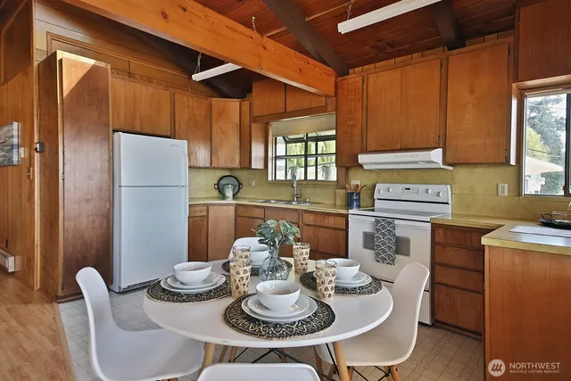 a kitchen with a table and chairs in it