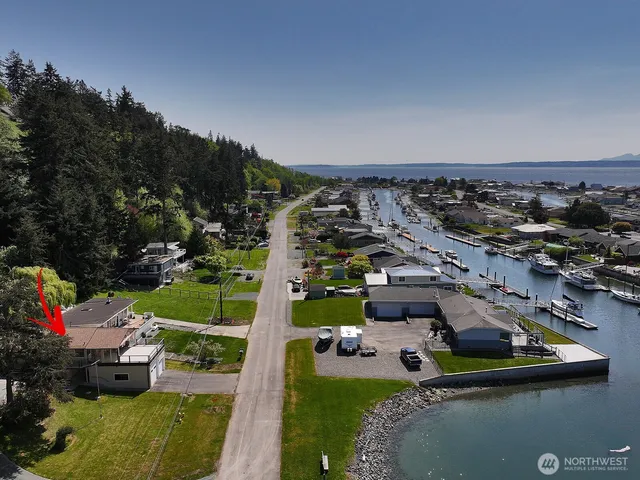 an aerial view of a house with a garden and lake view