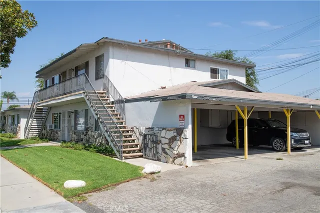 a view of a house with a porch and furniture