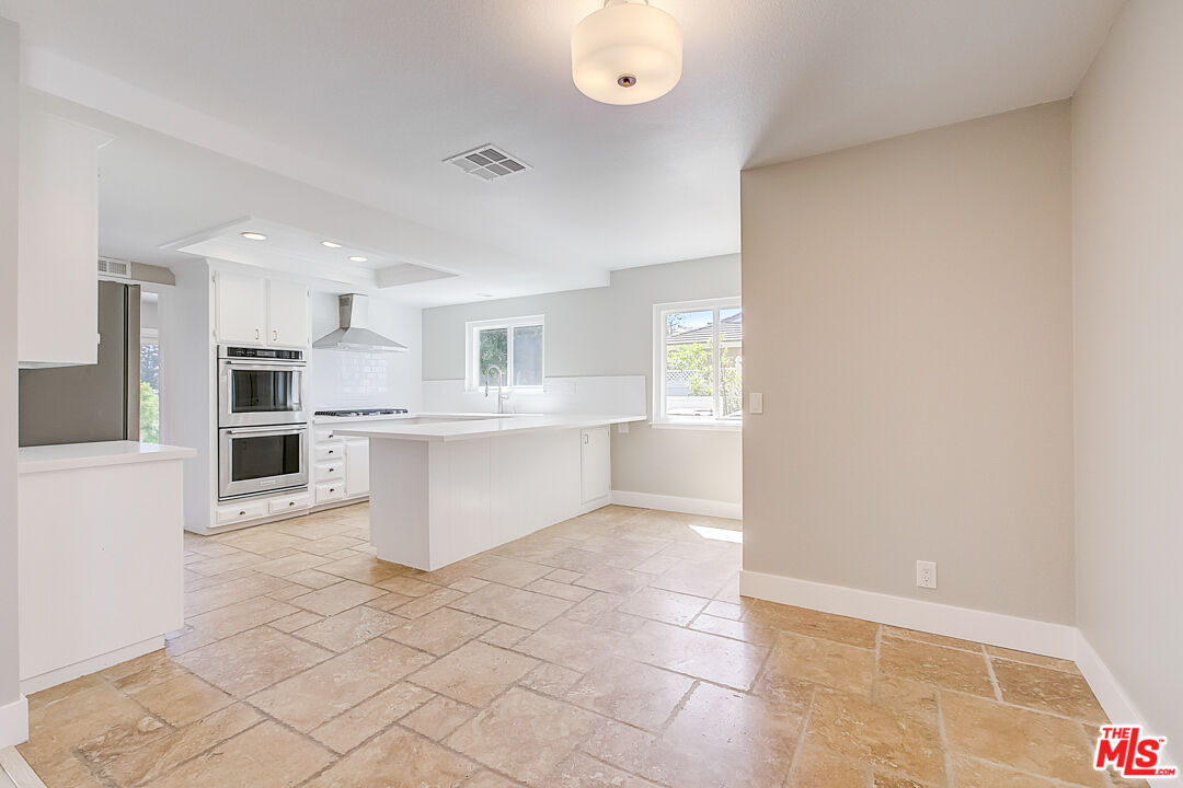19412 Old Ranch Road Yorba Linda, CA 92886 - Photo 11 of 35 a large white kitchen with a sink and cabinets