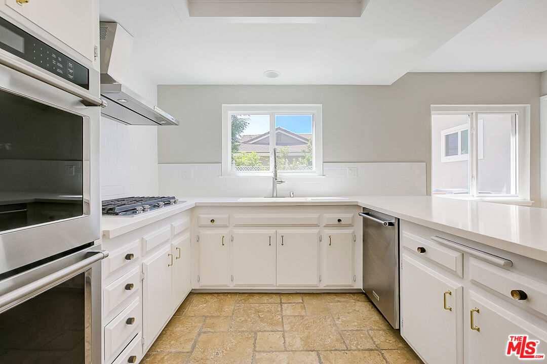 19412 Old Ranch Road Yorba Linda, CA 92886 - Photo 17 of 35 a kitchen with white cabinets and white appliances