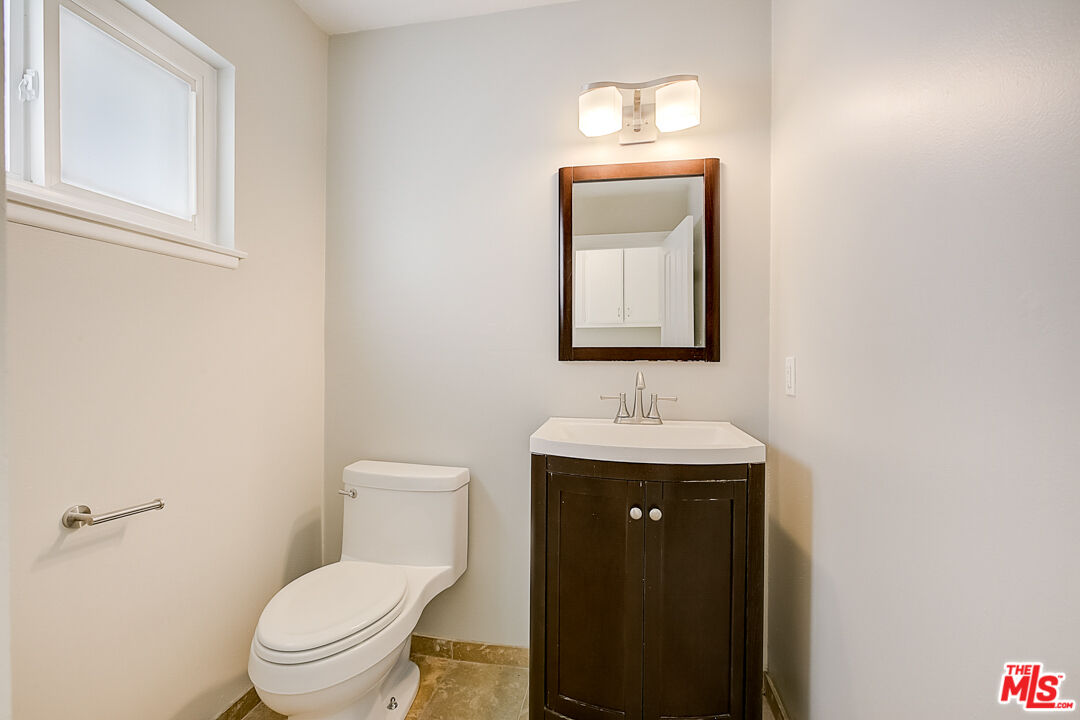 19412 Old Ranch Road Yorba Linda, CA 92886 - Photo 18 of 35 a bathroom with a toilet a sink and mirror