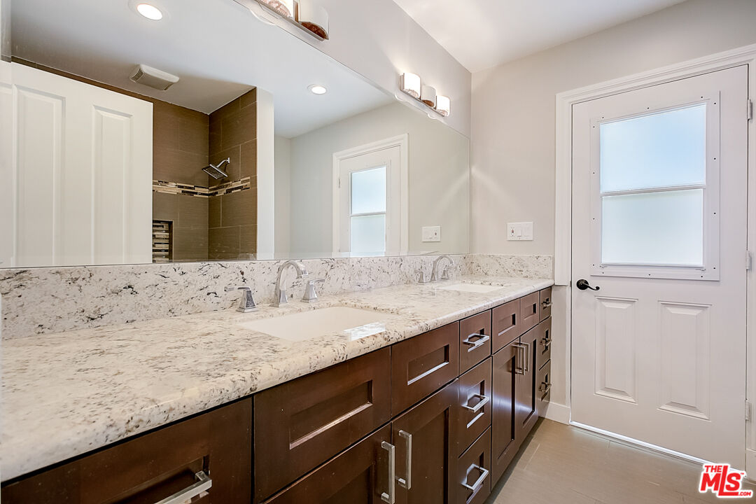 19412 Old Ranch Road Yorba Linda, CA 92886 - Photo 23 of 35 a bathroom with a granite countertop sink and a mirror