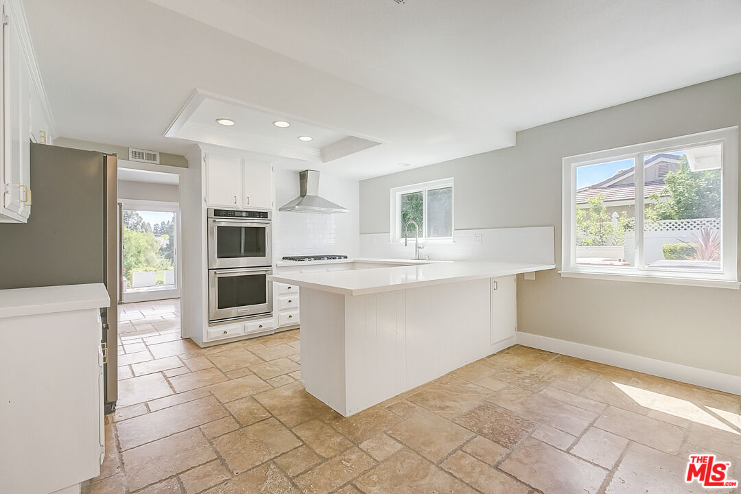 19412 Old Ranch Road Yorba Linda, CA 92886 - Photo 4 of 35 a large white kitchen with a stove a sink dishwasher and a refrigerator