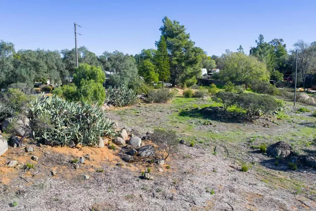 a backyard of a house with a yard and outdoor seating