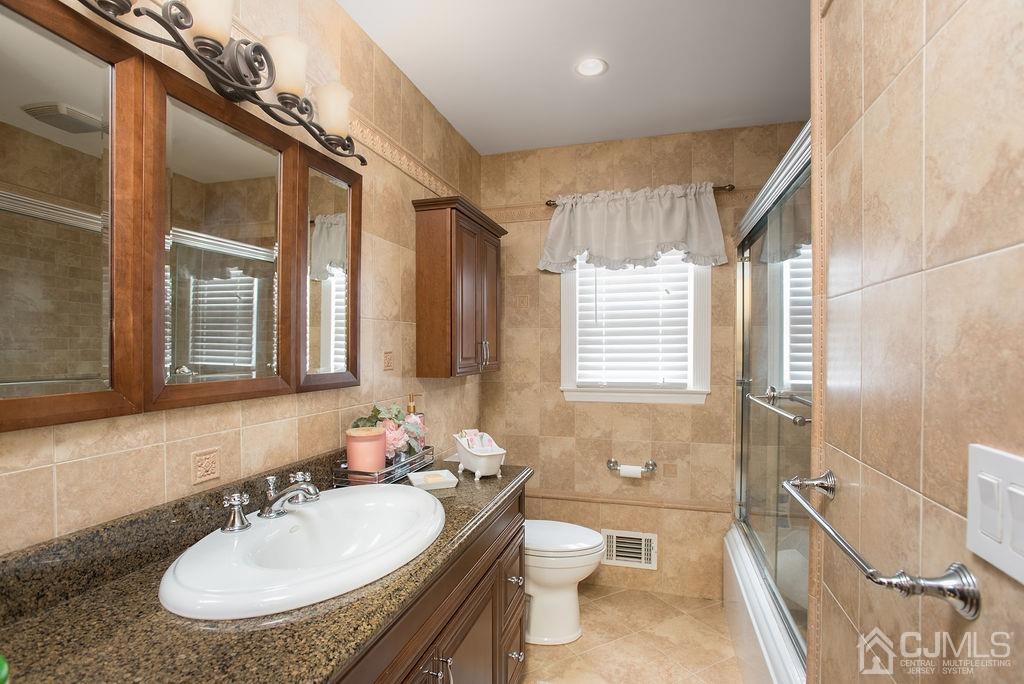 18 Layne Road Somerset, NJ 08873 - Photo 15 of 22 a bathroom with a granite countertop sink and a mirror
