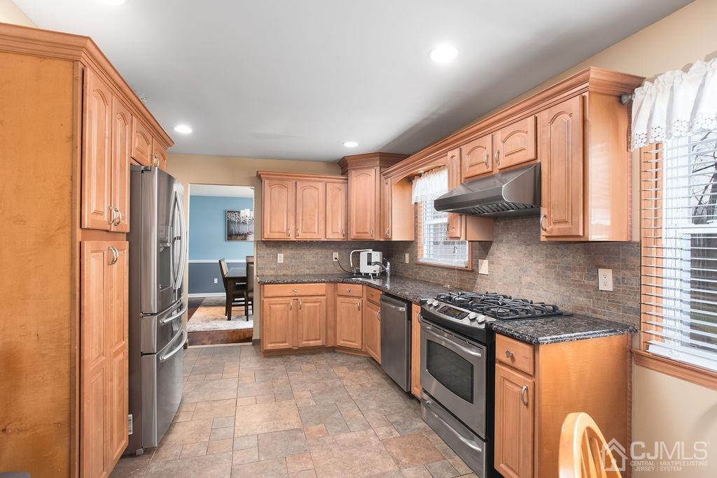 18 Layne Road Somerset, NJ 08873 - Photo 6 of 22 a kitchen with stainless steel appliances granite countertop a stove top oven a sink a dining table and chairs