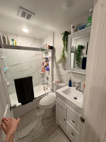 a bathroom with a sink toilet and mirror