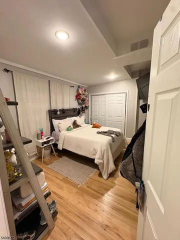 a bedroom with a bed a mirror and a desk