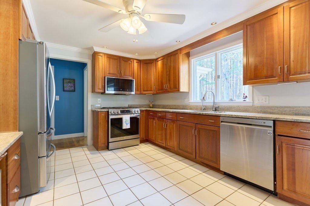 58 Buttercup Lane Hanover, MA 02339 - Photo 11 of 35 a kitchen with stainless steel appliances granite countertop a stove sink and microwave