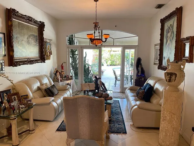a living room with furniture a flat screen tv and a large window