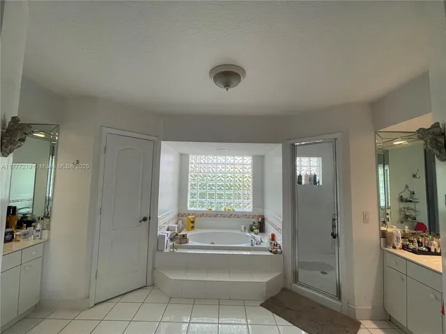 a bathroom with a tub sink and mirror