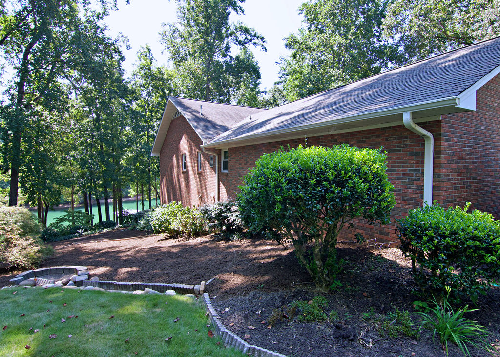 11001 Lake Ridge Lane Seneca, SC 29672 - Photo 8 of 50 Mature trees frame a classic brick home situated along the tranquil shoreline.