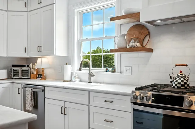 a kitchen with a stove cabinets and wooden floor