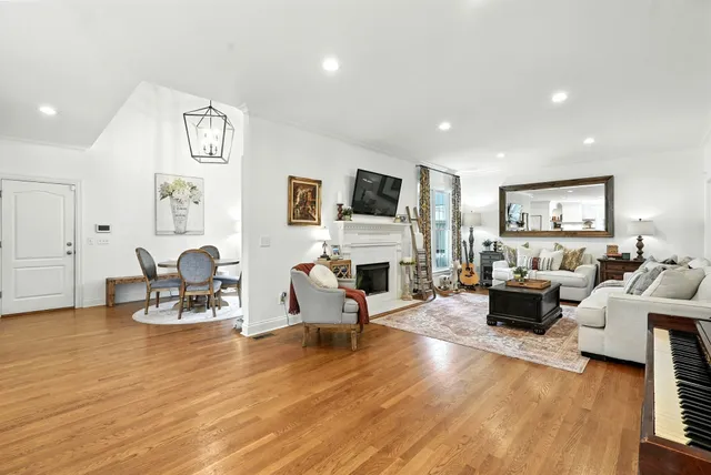 a living room with furniture a fireplace and a flat screen tv