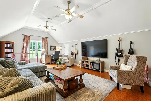 a view of hallway with wooden floor and windows