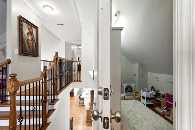 a view of hallway with livingroom and hardwood floor