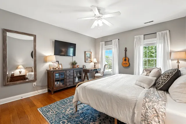 a bedroom with furniture and a wooden floor