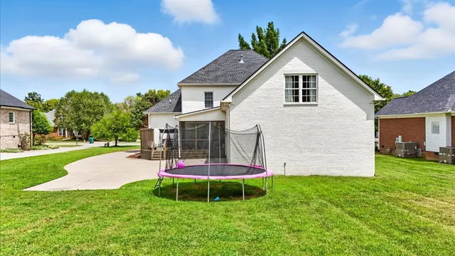 an aerial view of residential houses with outdoor space and street view