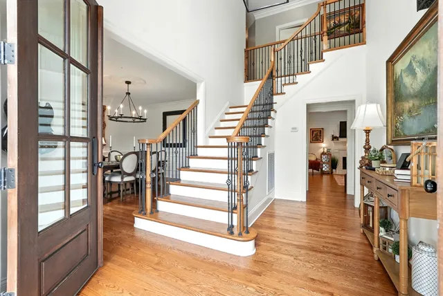 a view of entryway and hall with wooden floor