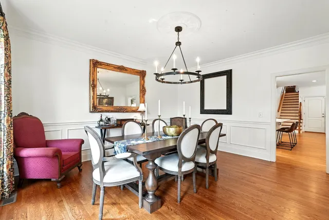a view of a dining room with furniture wooden floor and chandelier