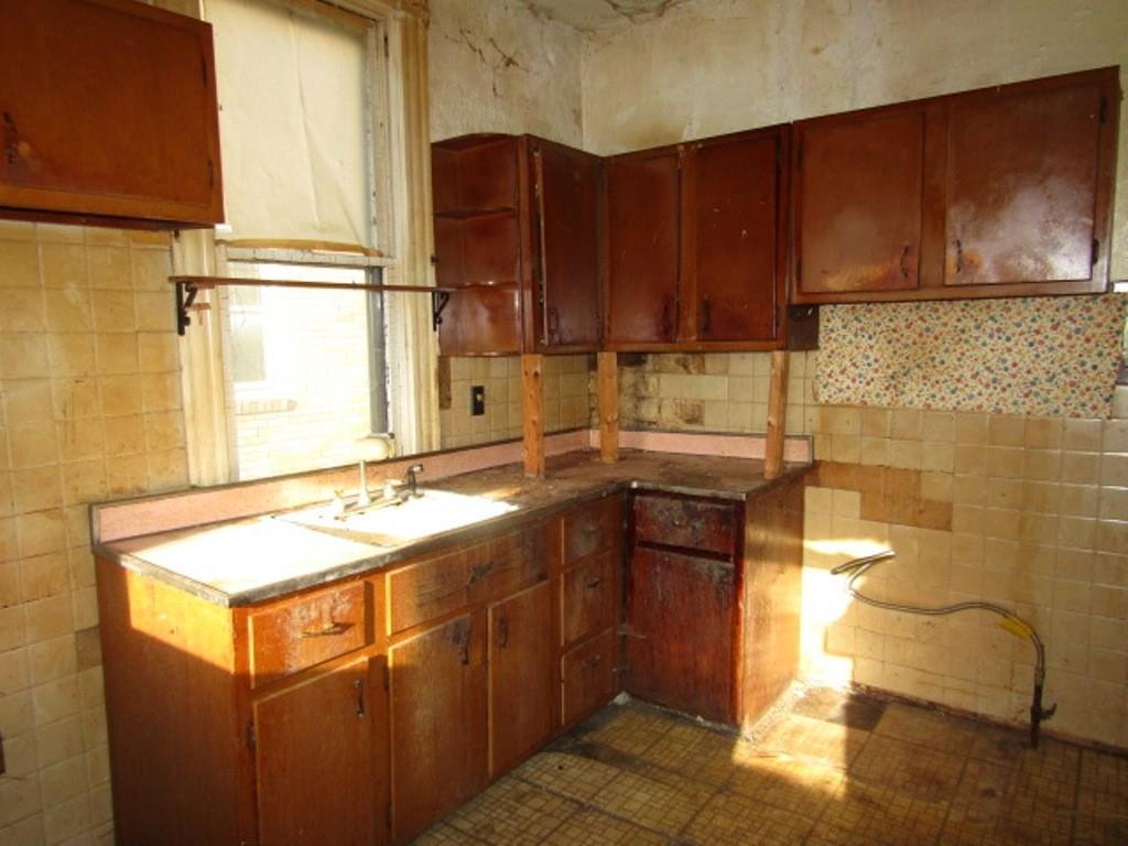1219 Tweed Street Pittsburgh, PA 15204 - Photo 14 of 30 a kitchen with a sink stove and cabinets