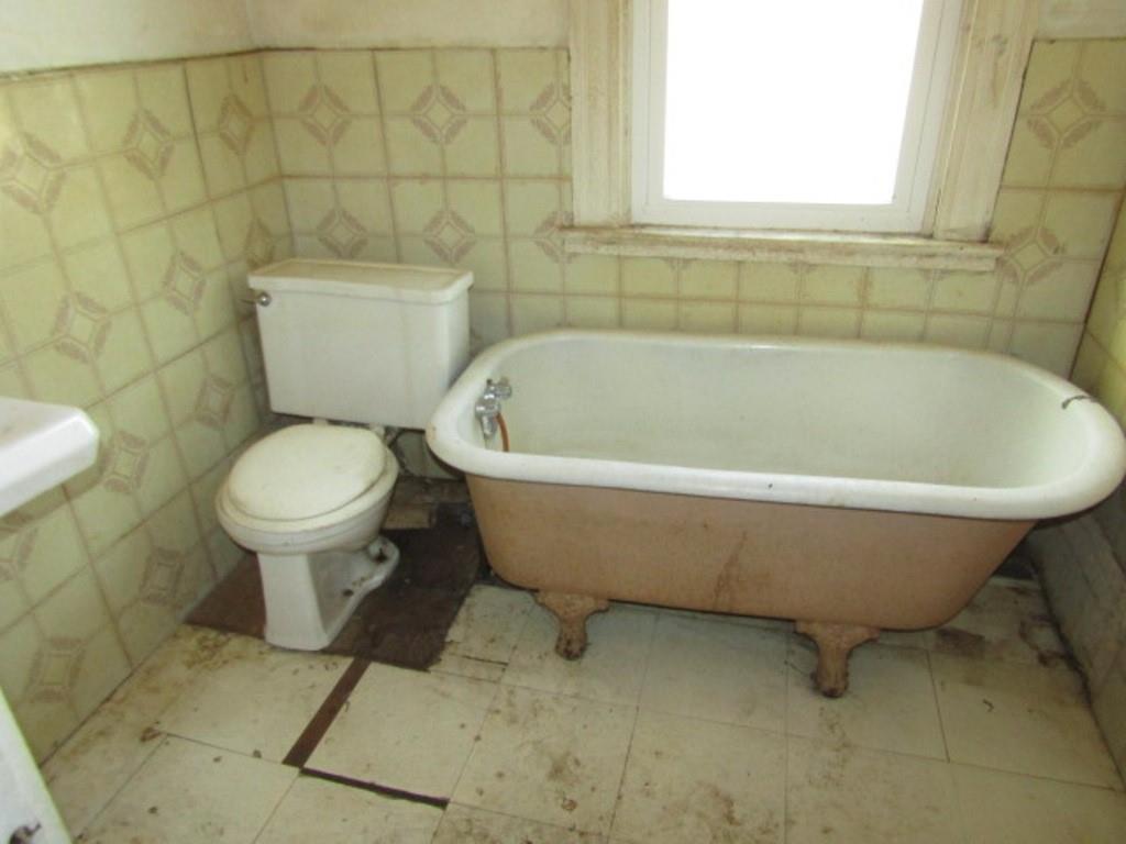 1219 Tweed Street Pittsburgh, PA 15204 - Photo 18 of 30 a white toilet sitting next to a bathroom sink