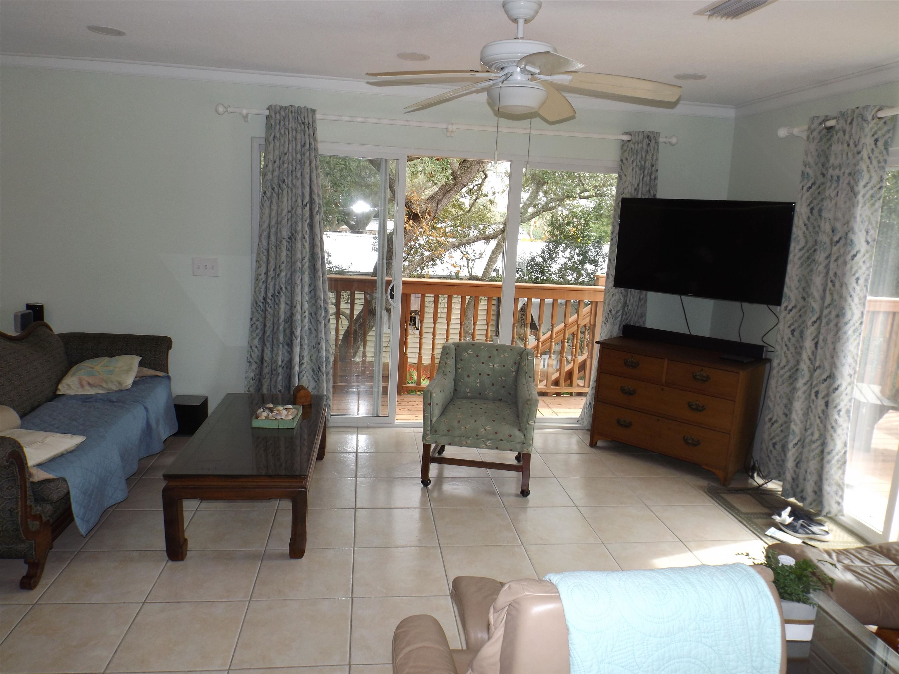 237 Villa Verda Road St. Augustine, FL 32080 - Photo 15 of 48 a living room with furniture a flat screen tv and a window