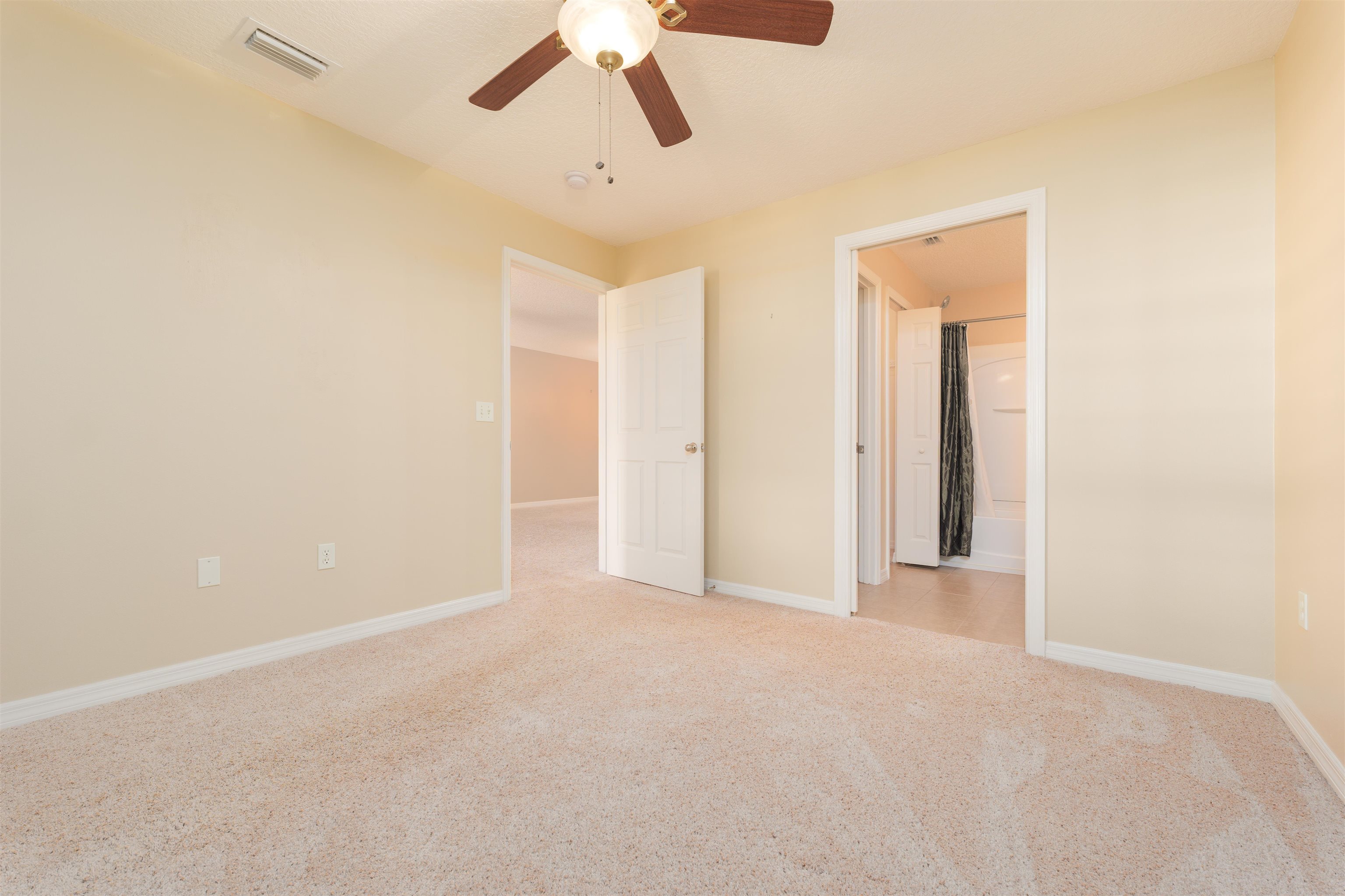 99 Broad River Place, Unit 3205 Welaka, FL 32193 - Photo 20 of 33 an empty room with chandelier fan and windows