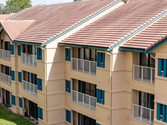 a view of white house with large windows