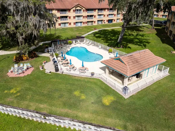 a aerial view of a house with swimming pool garden and patio