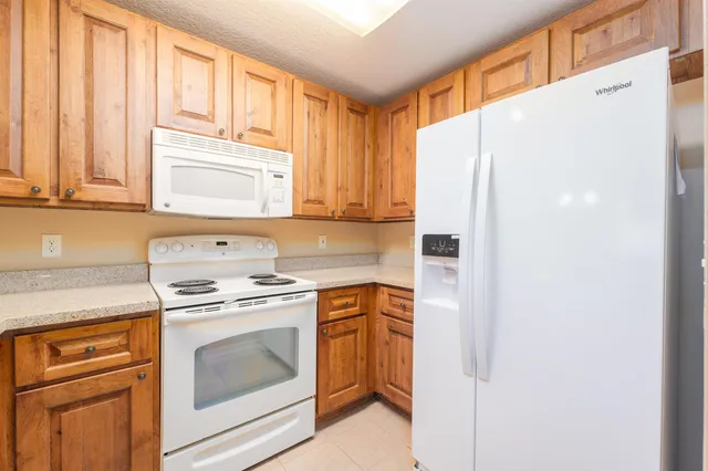 a kitchen with a stove top oven sink and refrigerator