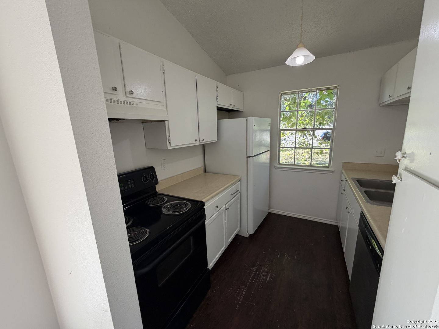 12200 Ridge Crown Street San Antonio, TX 78247 - Photo 11 of 20 a kitchen with granite countertop a stove a sink and a microwave