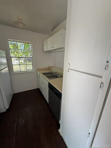 a kitchen with a stove a refrigerator and a sink