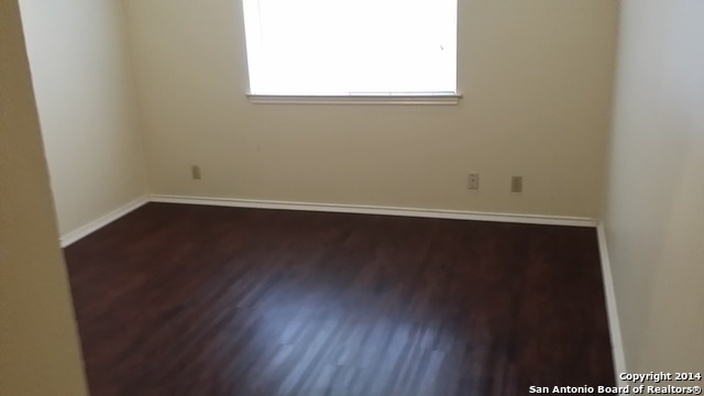 12200 Ridge Crown Street San Antonio, TX 78247 - Photo 8 of 20 an empty room with wooden floor and windows