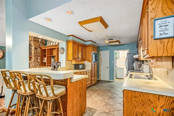 a kitchen with stainless steel appliances granite countertop a refrigerator and a sink
