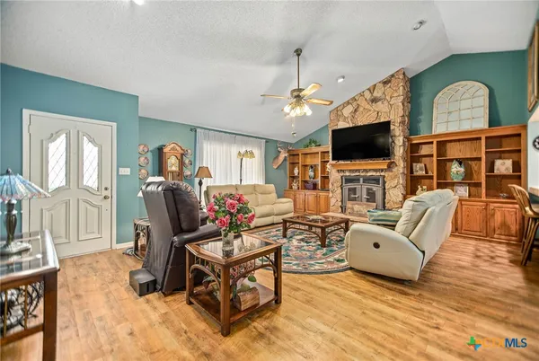 a living room with furniture a chandelier and a fireplace
