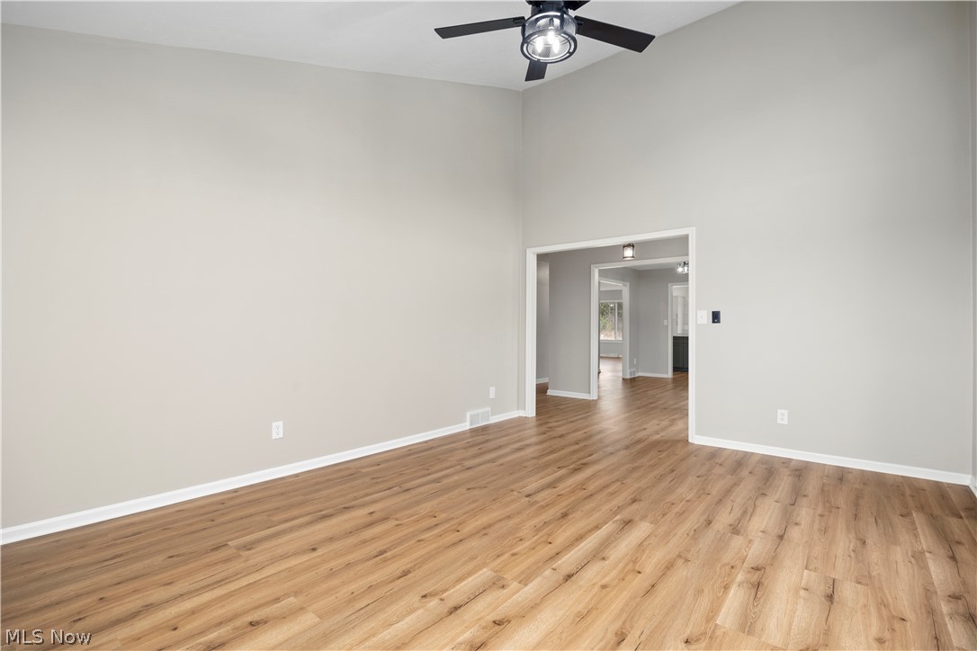 36220 Neff Road Grafton, OH 44044 - Photo 8 of 50 Empty room featuring a high ceiling, light wood-type flooring, and ceiling fan