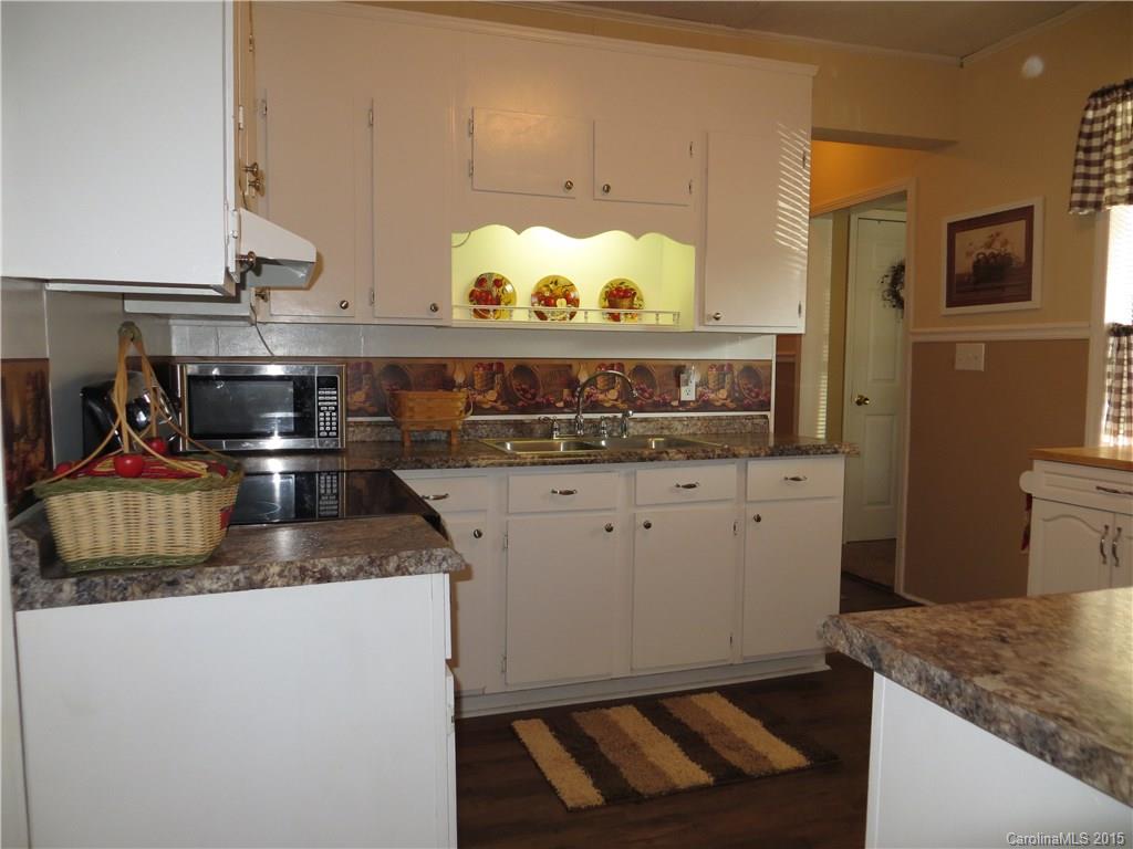 732 Ike Lynch Road Dallas, NC 28034 - Photo 17 of 24 a kitchen with granite countertop a sink and a stove